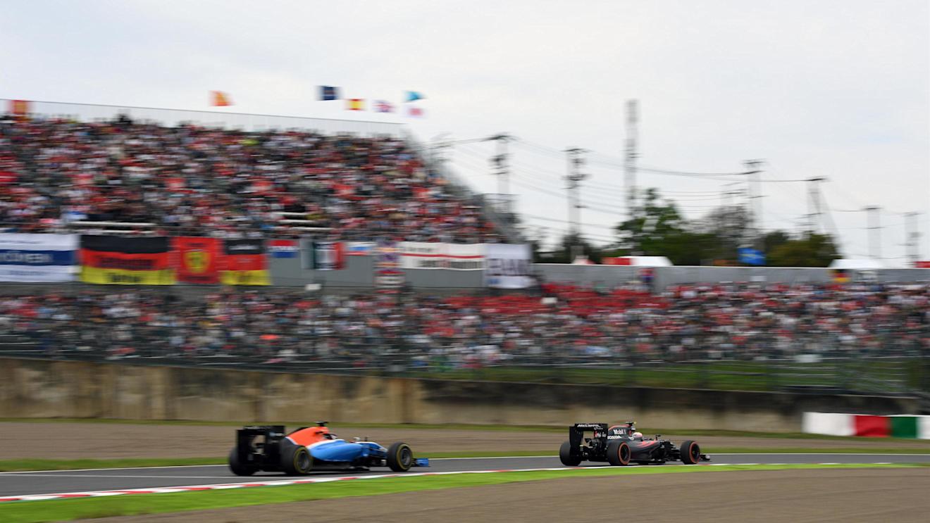 Jenson Button (GBR) McLaren MP4-31 and Pascal Wehrlein (GER) Manor Racing MRT05 at Formula One World Championship, Rd17, Japanese Grand Prix, Race, Suzuka, Japan, Sunday 9 October 2016. © Sutton Images