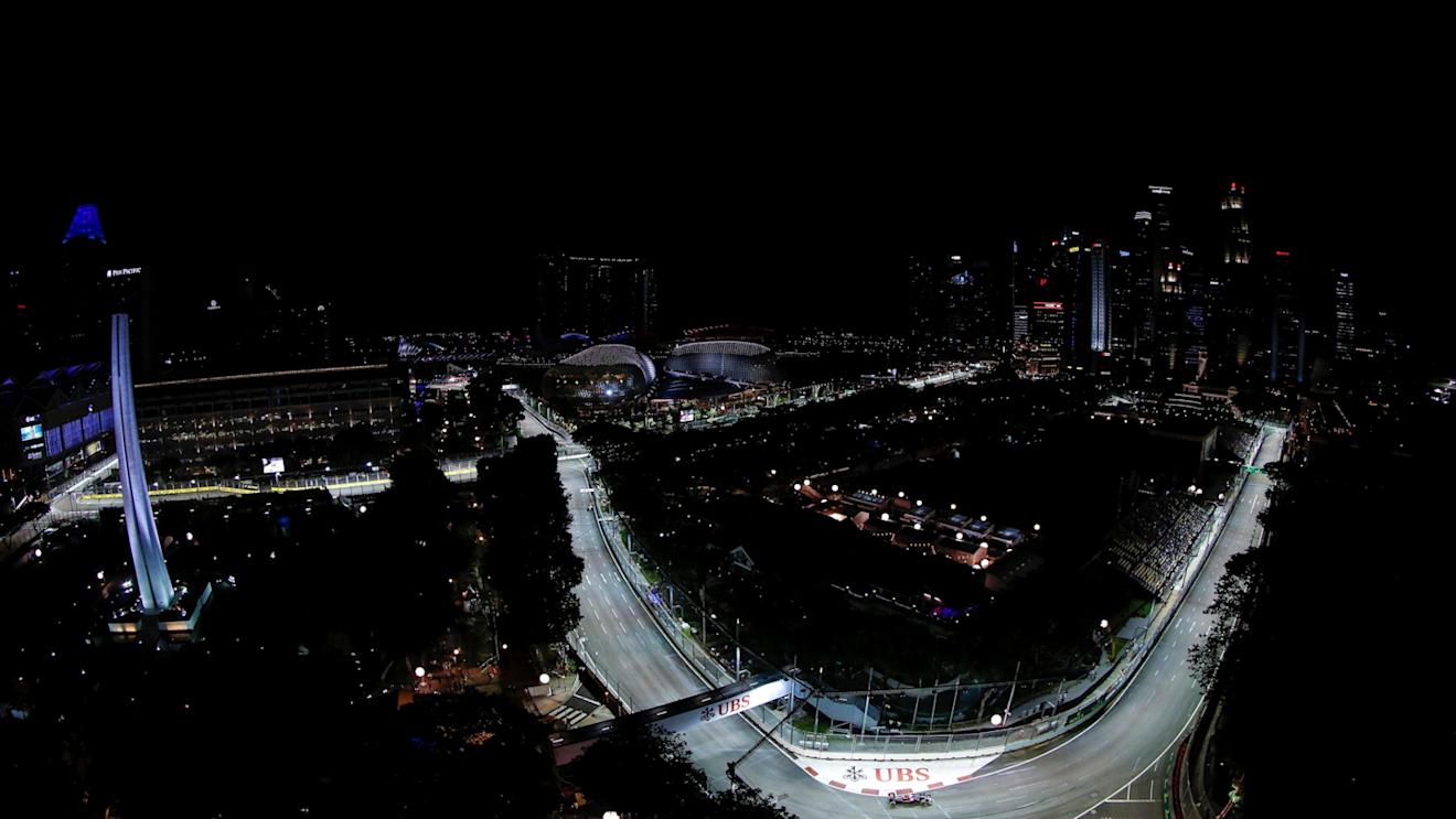 Jenson Button (GBR) McLaren MP4-31 and Romain Grosjean (FRA) Haas VF-16 at Formula One World Championship, Rd15, Singapore Grand Prix, Practice, Marina Bay Street Circuit, Singapore, Friday 16 September 2016. © Sutton Images