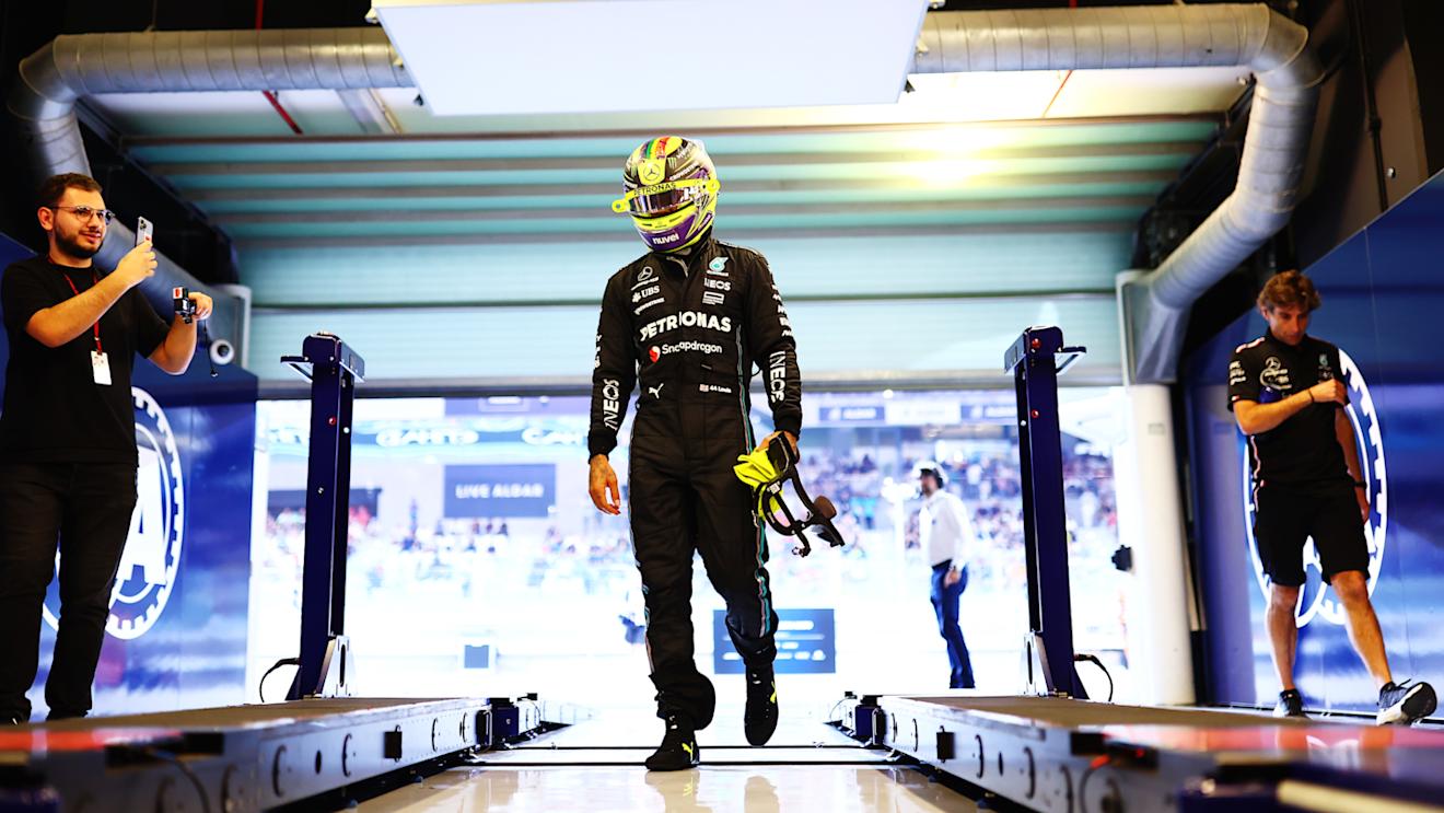 ABU DHABI, UNITED ARAB EMIRATES - NOVEMBER 25: 11th placed qualifier Lewis Hamilton of Great Britain and Mercedes walks in the FIA garage during qualifying ahead of the F1 Grand Prix of Abu Dhabi at Yas Marina Circuit on November 25, 2023 in Abu Dhabi, United Arab Emirates. (Photo by Dan Istitene - Formula 1/Formula 1 via Getty Images)