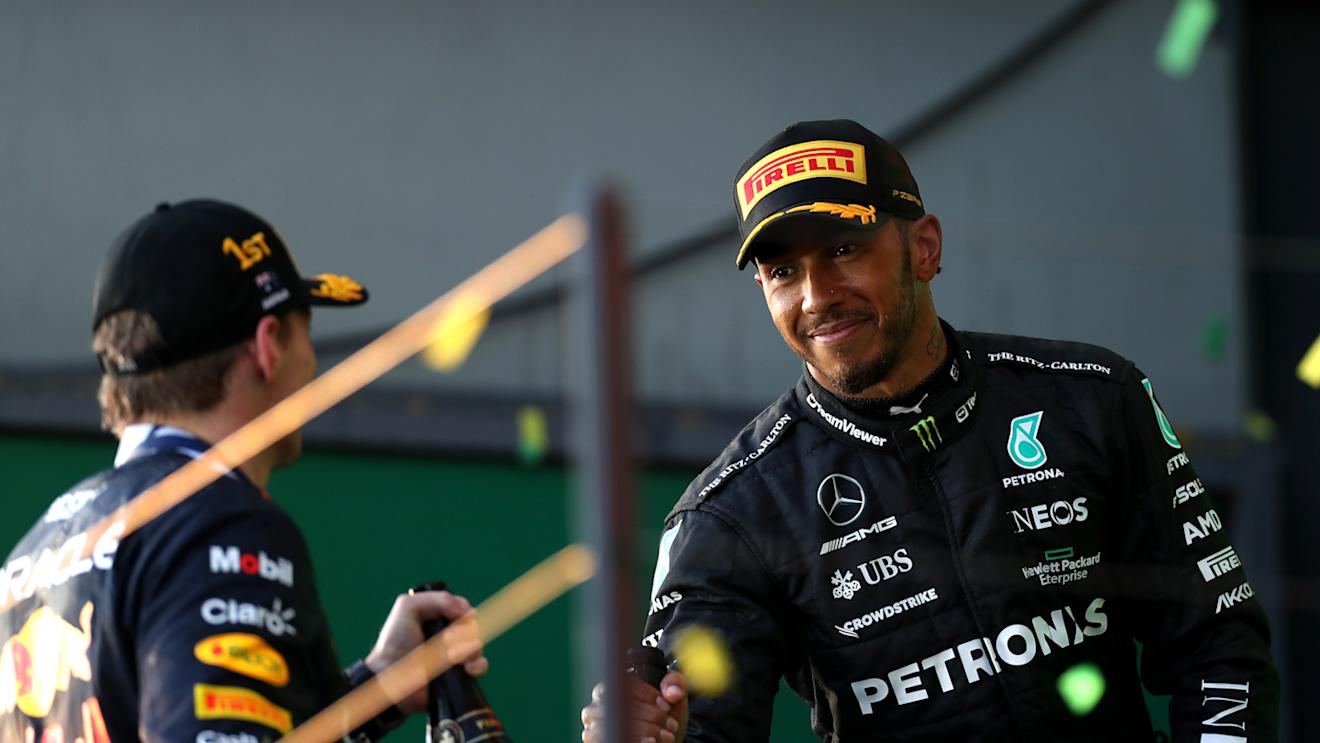 MELBOURNE, AUSTRALIA - APRIL 02: Race winner Max Verstappen of the Netherlands and Oracle Red Bull Racing and  Second placed Lewis Hamilton of Great Britain celebrate on the podium during the F1 Grand Prix of Australia at Albert Park Grand Prix Circuit on April 02, 2023 in Melbourne, Australia. (Photo by Peter Fox/Getty Images)