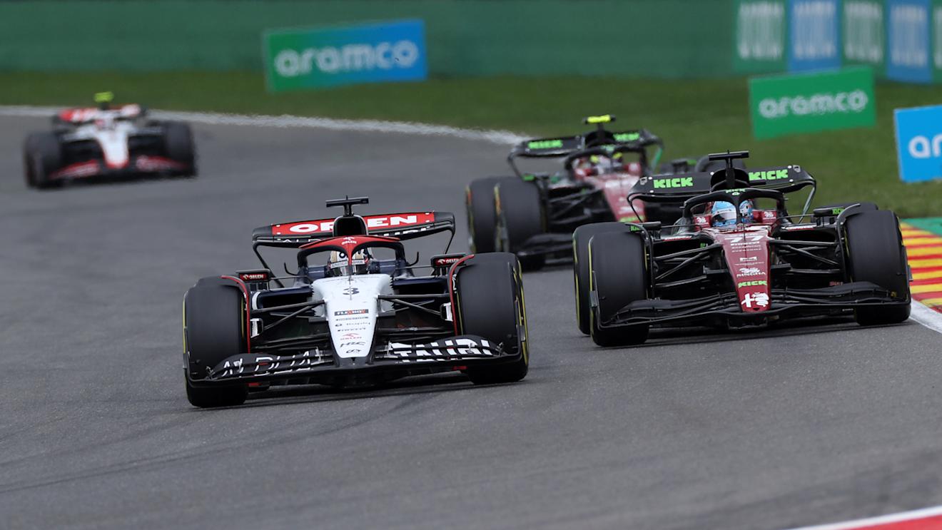 SPA, BELGIUM - JULY 30: Daniel Ricciardo of Australia driving the (3) Scuderia AlphaTauri AT04 leads Valtteri Bottas of Finland driving the (77) Alfa Romeo F1 C43 Ferrari during the F1 Grand Prix of Belgium at Circuit de Spa-Francorchamps on July 30, 2023 in Spa, Belgium. (Photo by Peter Fox/Getty Images)