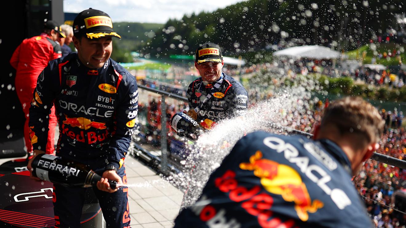 SPA, BELGIUM - JULY 30: Race winner Max Verstappen of the Netherlands and Oracle Red Bull Racing, Second placed Sergio Perez of Mexico and Oracle Red Bull Racing and Greg Reeson, Tyre Technician at Red Bull Racing celebrate on the podium during the F1 Grand Prix of Belgium at Circuit de Spa-Francorchamps on July 30, 2023 in Spa, Belgium. (Photo by Dan Istitene - Formula 1/Formula 1 via Getty Images)