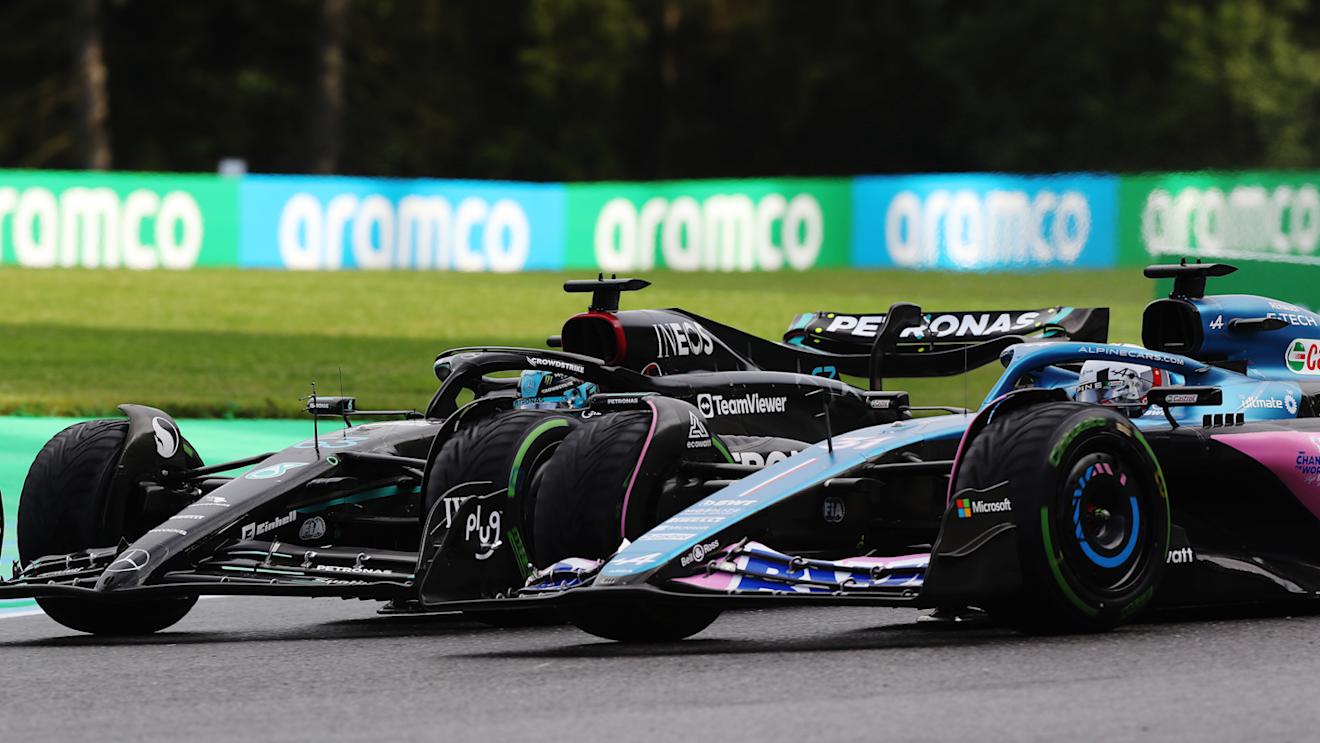 SPA, BELGIUM - JULY 29: George Russell of Great Britain driving the (63) Mercedes AMG Petronas F1 Team W14 and Esteban Ocon of France driving the (31) Alpine F1 A523 Renault battle for track position during the Sprint ahead of the F1 Grand Prix of Belgium at Circuit de Spa-Francorchamps on July 29, 2023 in Spa, Belgium. (Photo by Peter Fox/Getty Images)