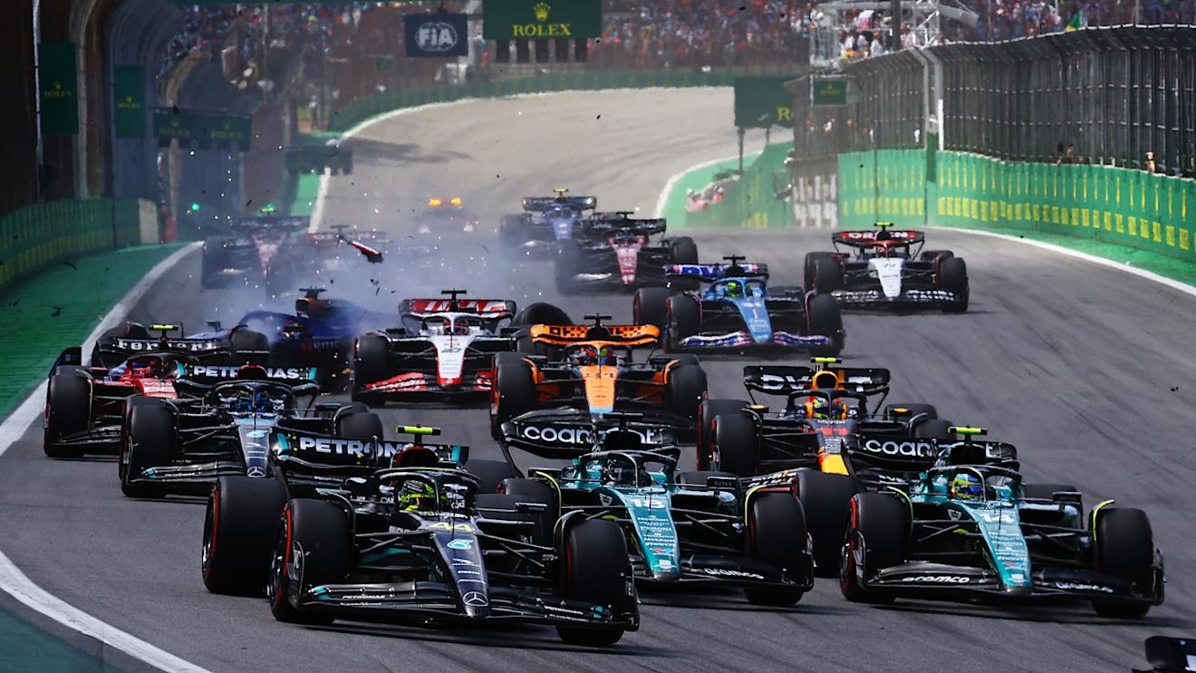 SAO PAULO, BRAZIL - NOVEMBER 05: Lewis Hamilton of Great Britain driving the (44) Mercedes AMG Petronas F1 Team W14, Lance Stroll of Canada driving the (18) Aston Martin AMR23 Mercedes and Fernando Alonso of Spain driving the (14) Aston Martin AMR23 Mercedes battle for track position into turn 1 of the F1 Grand Prix of Brazil on November 05, 2023 (Photo by Mark Thompson/Getty Images)