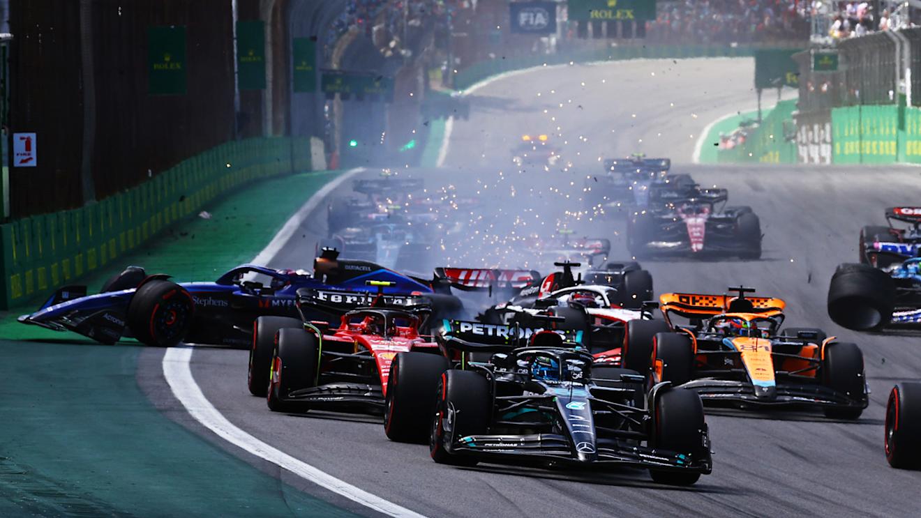 SAO PAULO, BRAZIL - NOVEMBER 05: Alexander Albon of Thailand driving the (23) Williams FW45 Mercedes and Kevin Magnussen of Denmark driving the (20) Haas F1 VF-23 Ferrari (obscured) crash into turn one at the start during the F1 Grand Prix of Brazil at Autodromo Jose Carlos Pace on November 05, 2023 in Sao Paulo, Brazil. (Photo by Mark Thompson/Getty Images)