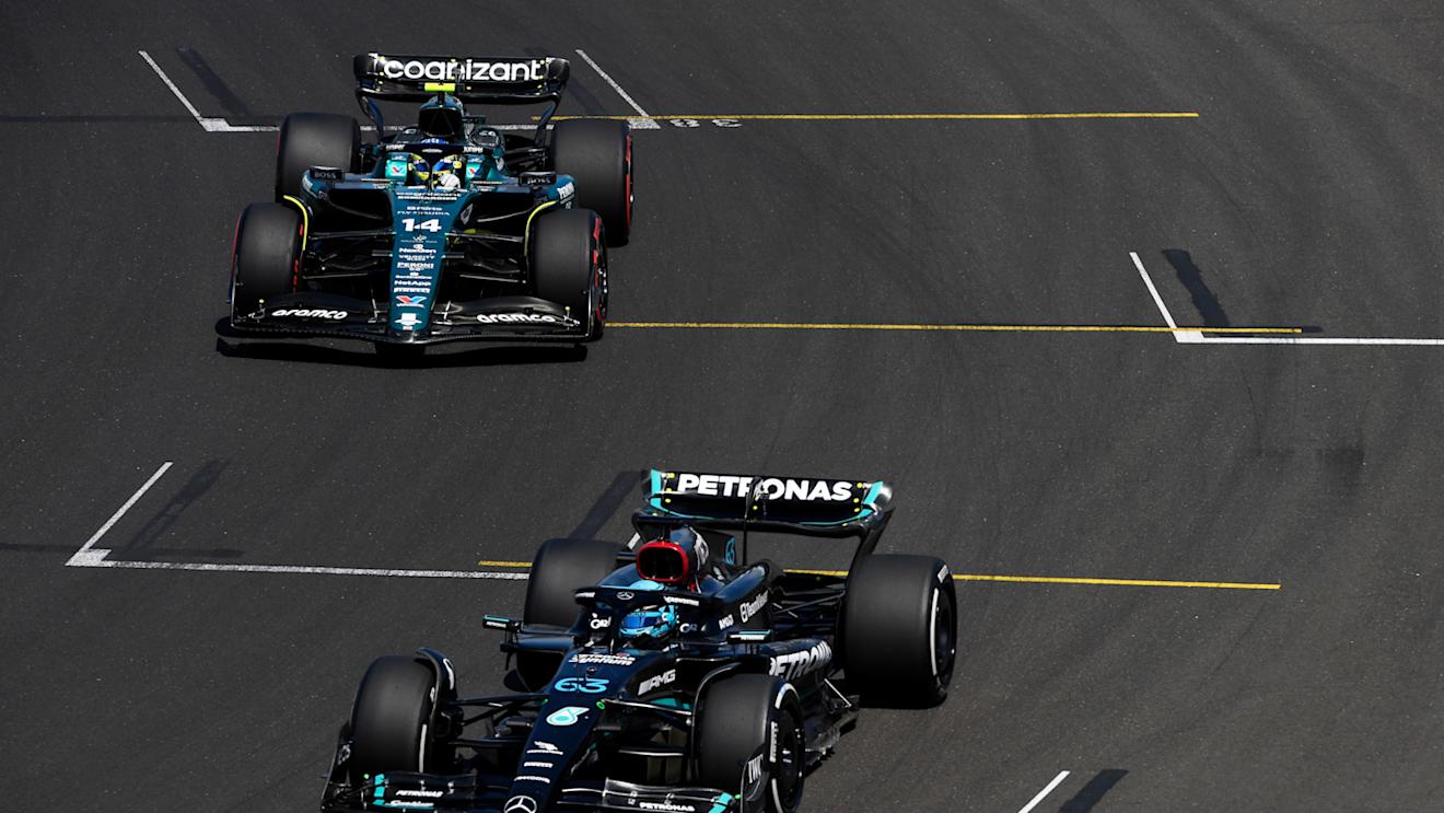 BUDAPEST, HUNGARY - JULY 23: George Russell of Great Britain driving the (63) Mercedes AMG Petronas F1 Team W14 and Fernando Alonso of Spain driving the (14) Aston Martin AMR23 Mercedes make their way to the grid prior to the F1 Grand Prix of Hungary at Hungaroring on July 23, 2023 in Budapest, Hungary. (Photo by Rudy Carezzevoli - Formula 1/Formula 1 via Getty Images)