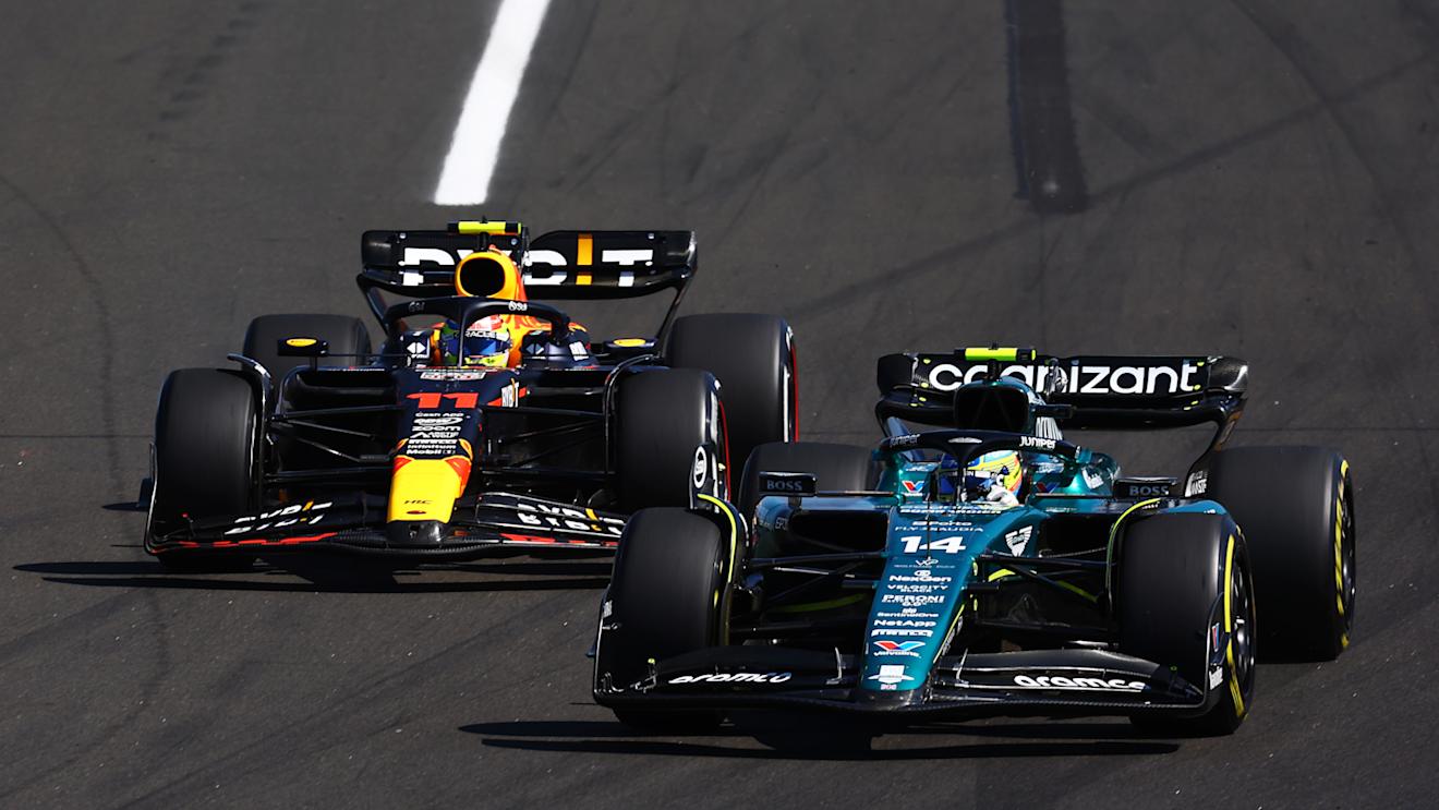 BUDAPEST, HUNGARY - JULY 23: Fernando Alonso of Spain driving the (14) Aston Martin AMR23 Mercedes leads Sergio Perez of Mexico driving the (11) Oracle Red Bull Racing RB19 during the F1 Grand Prix of Hungary at Hungaroring on July 23, 2023 in Budapest, Hungary. (Photo by Mark Thompson/Getty Images)