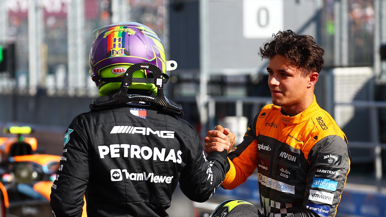 BUDAPEST, HUNGARY - JULY 22: Pole position qualifier Lewis Hamilton of Great Britain and Mercedes and Third placed qualifier Lando Norris of Great Britain and McLaren talk in parc ferme during qualifying ahead of the F1 Grand Prix of Hungary at Hungaroring on July 22, 2023 in Budapest, Hungary. (Photo by Mark Thompson/Getty Images)