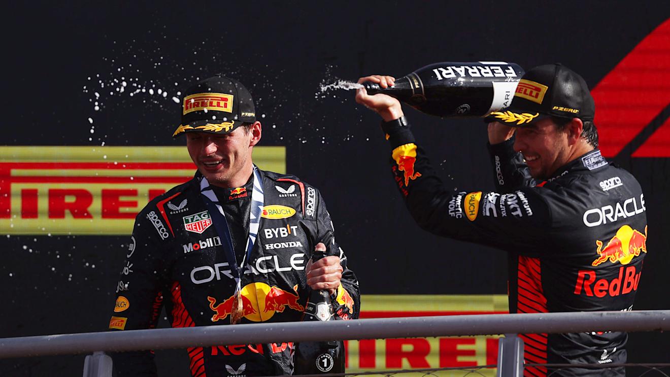 MONZA, ITALY - SEPTEMBER 03: Race winner Max Verstappen of the Netherlands and Oracle Red Bull Racing and Second placed Sergio Perez of Mexico and Oracle Red Bull Racing celebrate on the podium during the F1 Grand Prix of Italy at Autodromo Nazionale Monza on September 03, 2023 in Monza, Italy. (Photo by Ryan Pierse/Getty Images)