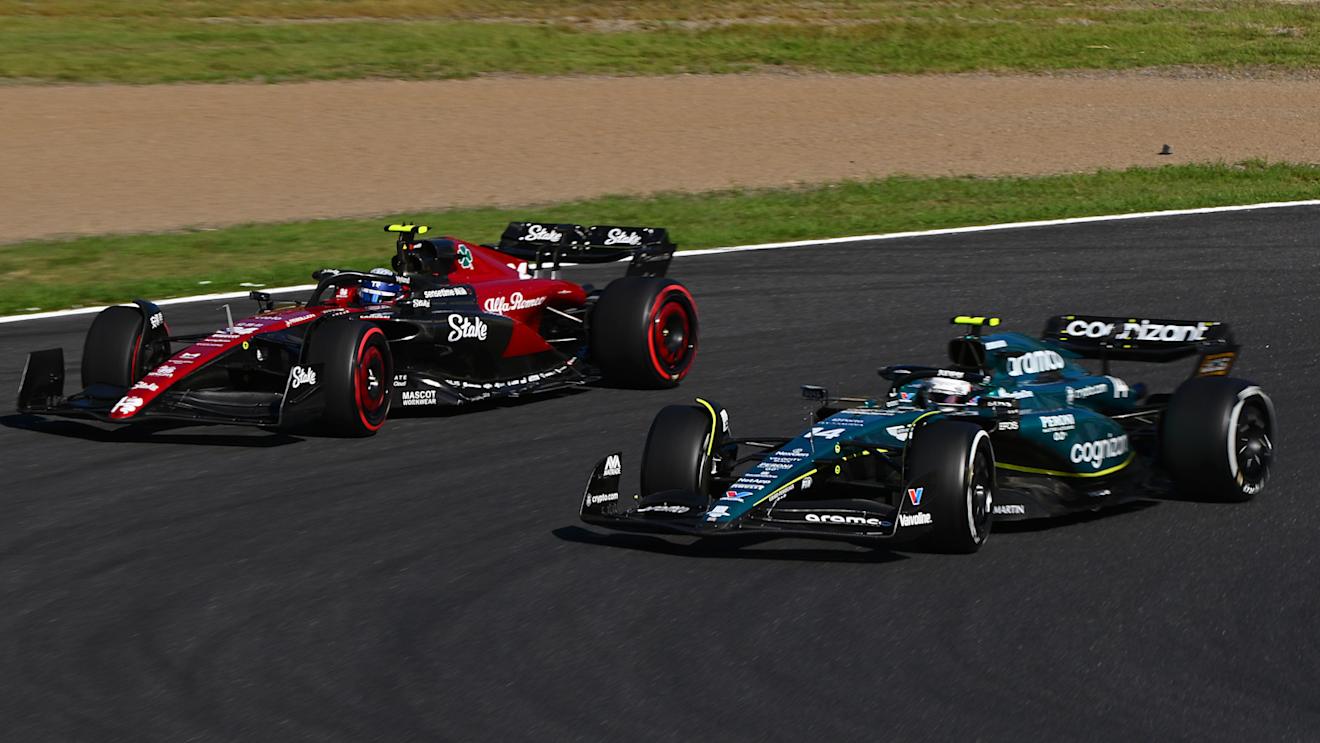 SUZUKA, JAPAN - SEPTEMBER 24: Fernando Alonso of Spain driving the (14) Aston Martin AMR23 Mercedes and Zhou Guanyu of China driving the (24) Alfa Romeo F1 C43 Ferrari compete for position on track during the F1 Grand Prix of Japan at Suzuka International Racing Course on September 24, 2023 in Suzuka, Japan. (Photo by Clive Mason/Getty Images)