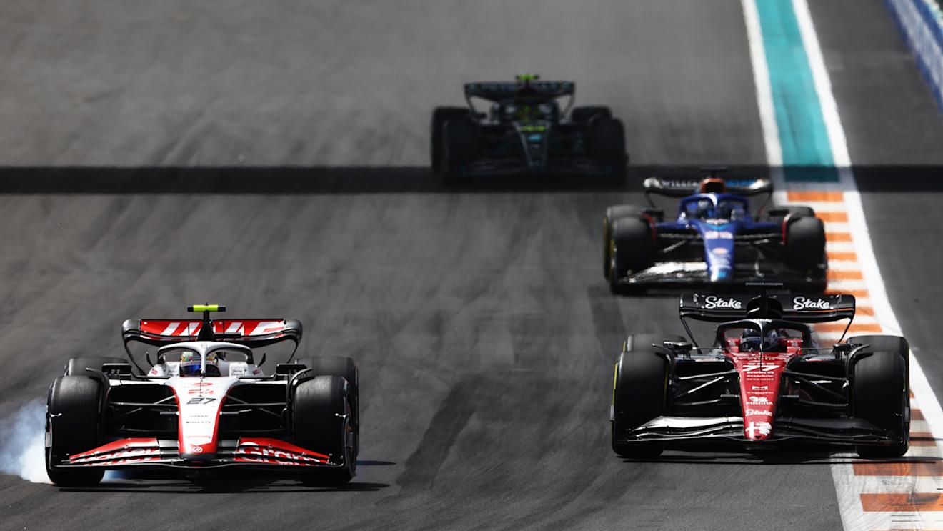 MIAMI, FLORIDA - MAY 07: Nico Hulkenberg of Germany driving the (27) Haas F1 VF-23 Ferrari locks a wheel under braking as he overtakes Valtteri Bottas of Finland driving the (77) Alfa Romeo F1 C43 Ferrari during the F1 Grand Prix of Miami at Miami International Autodrome on May 07, 2023 in Miami, Florida. (Photo by Mark Thompson/Getty Images)