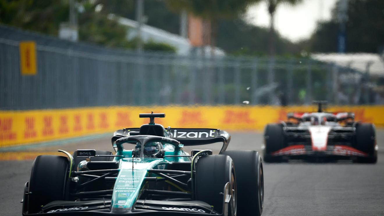 MIAMI, FLORIDA - MAY 07: Lance Stroll of Canada driving the (18) Aston Martin AMR23 Mercedes leads Kevin Magnussen of Denmark driving the (20) Haas F1 VF-23 Ferrari during the F1 Grand Prix of Miami at Miami International Autodrome on May 07, 2023 in Miami, Florida. (Photo by Jared C. Tilton/Getty Images)