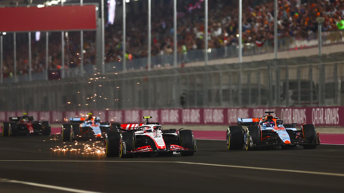 LUSAIL CITY, QATAR - OCTOBER 08: Nico Hulkenberg of Germany driving the (27) Haas F1 VF-23 Ferrari and Alexander Albon of Thailand driving the (23) Williams FW45 Mercedes battle for track position during the F1 Grand Prix of Qatar at Lusail International Circuit on October 08, 2023 in Lusail City, Qatar. (Photo by Dan Istitene - Formula 1/Formula 1 via Getty Images)