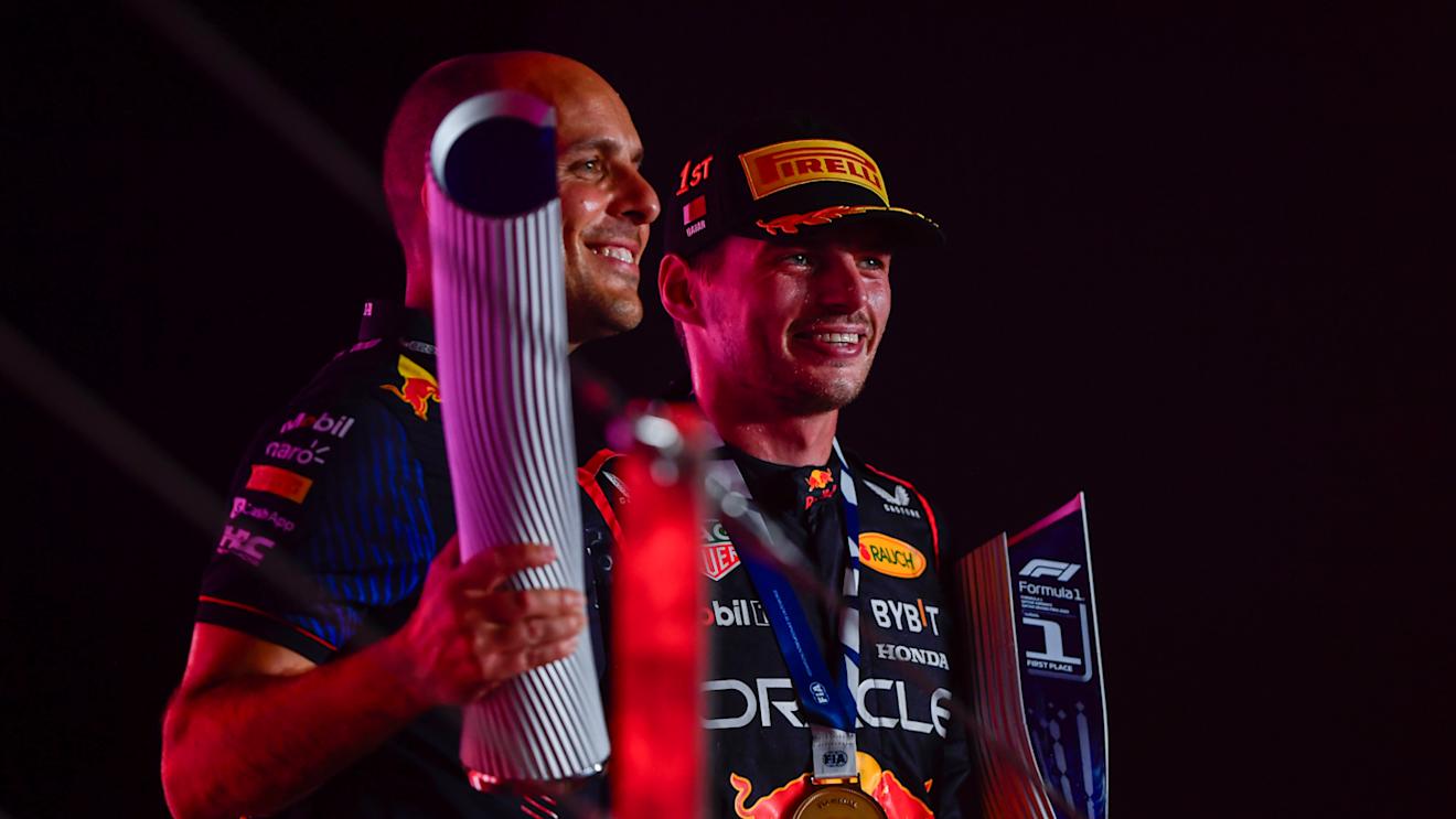 LUSAIL CITY, QATAR - OCTOBER 08: Race winner Max Verstappen of the Netherlands and Oracle Red Bull Racing and race engineer Gianpiero Lambiase celebrate on the podium during the F1 Grand Prix of Qatar at Lusail International Circuit on October 08, 2023 in Lusail City, Qatar. (Photo by Rudy Carezzevoli/Getty Images)