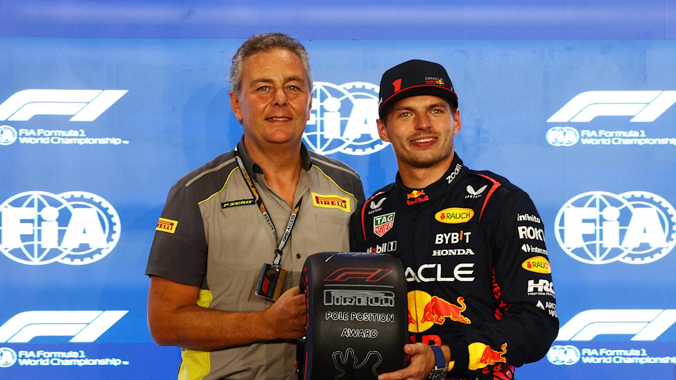 LUSAIL CITY, QATAR - OCTOBER 06: Pole position qualifier Max Verstappen of the Netherlands and Oracle Red Bull Racing is presented with the Pirelli Pole Position Trophy by Director of Pirelli F1 Mario Isola during qualifying ahead of the F1 Grand Prix of Qatar at Lusail International Circuit on October 06, 2023 in Lusail City, Qatar. (Photo by Mark Thompson/Getty Images)