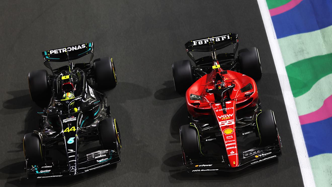 JEDDAH, SAUDI ARABIA - MARCH 19: Carlos Sainz of Spain driving (55) the Ferrari SF-23 and Lewis Hamilton of Great Britain driving the (44) Mercedes AMG Petronas F1 Team W14 battle for track position during the F1 Grand Prix of Saudi Arabia at Jeddah Corniche Circuit on March 19, 2023 in Jeddah, Saudi Arabia. (Photo by Lars Baron/Getty Images)