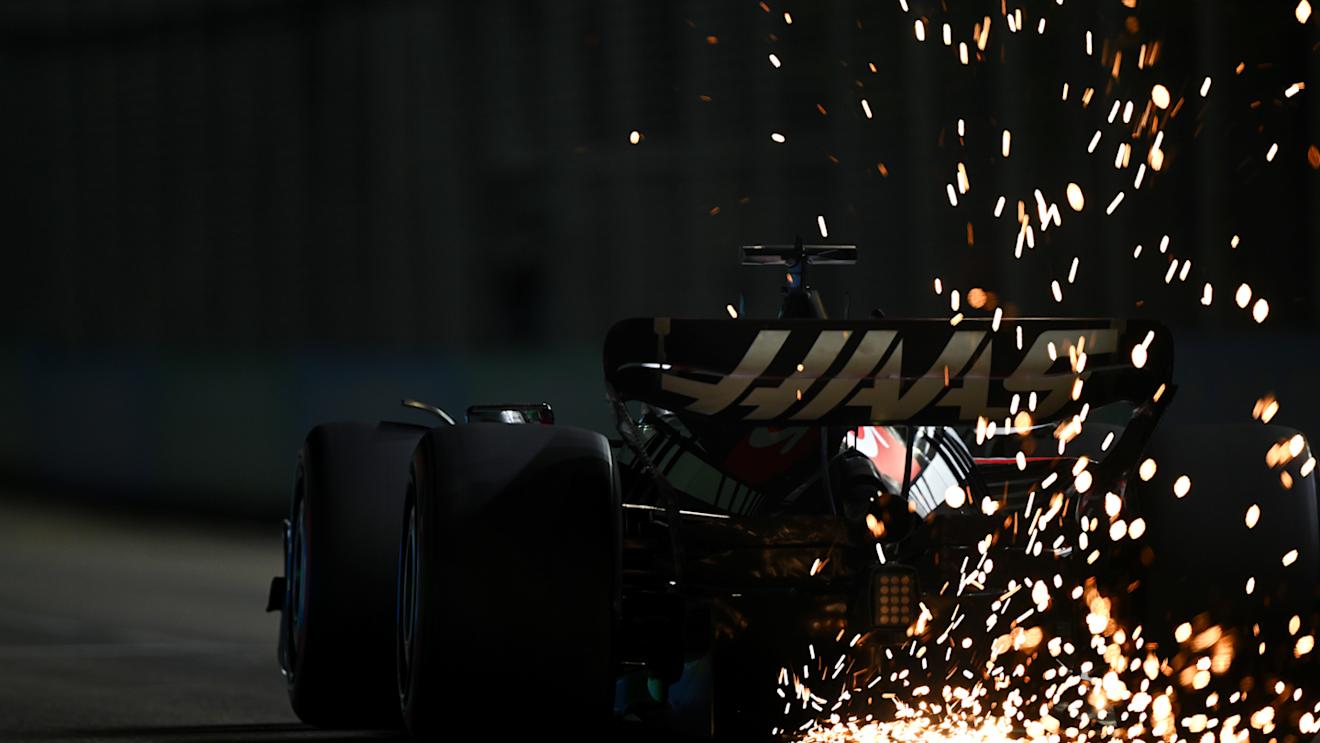 SINGAPORE, SINGAPORE - SEPTEMBER 16: Sparks fly from the car of Kevin Magnussen of Denmark driving the (20) Haas F1 VF-23 Ferrari during qualifying ahead of the F1 Grand Prix of Singapore at Marina Bay Street Circuit on September 16, 2023 in Singapore, Singapore. (Photo by Clive Mason/Getty Images)