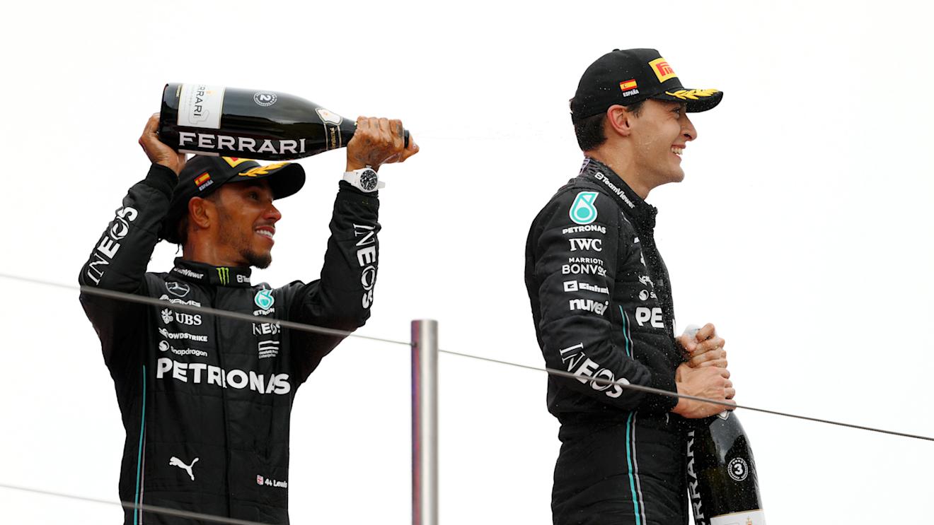 BARCELONA, SPAIN - JUNE 04: Second placed Lewis Hamilton of Great Britain and Mercedes and Third placed George Russell of Great Britain driving the (63) Mercedes AMG Petronas F1 Team W14 celebrate on the podium during the F1 Grand Prix of Spain at Circuit de Barcelona-Catalunya on June 04, 2023 in Barcelona, Spain. (Photo by David Ramos/Getty Images)
