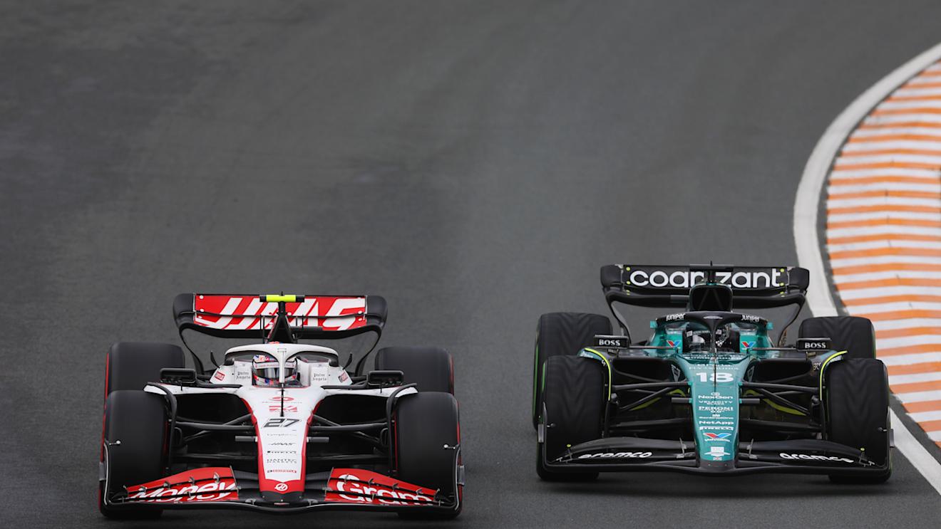 ZANDVOORT, NETHERLANDS - AUGUST 27: Nico Hulkenberg of Germany driving the (27) Haas F1 VF-23 Ferrari and Lance Stroll of Canada driving the (18) Aston Martin AMR23 Mercedes battle for track position during the F1 Grand Prix of The Netherlands at Circuit Zandvoort on August 27, 2023 in Zandvoort, Netherlands. (Photo by Lars Baron/Getty Images)
