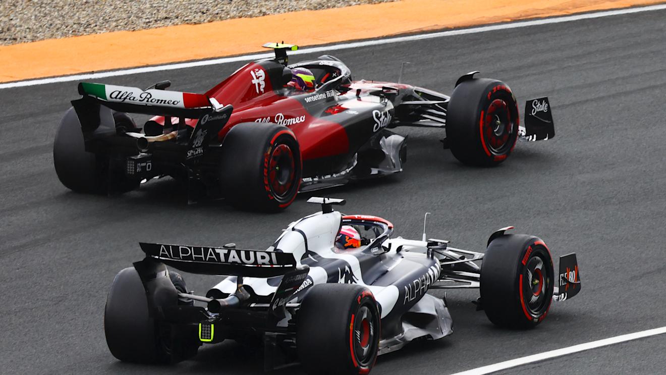 ZANDVOORT, NETHERLANDS - AUGUST 27: Liam Lawson of New Zealand driving the (40) Scuderia AlphaTauri AT04 and Zhou Guanyu of China driving the (24) Alfa Romeo F1 C43 Ferrari battle for track position during the F1 Grand Prix of The Netherlands at Circuit Zandvoort on August 27, 2023 in Zandvoort, Netherlands. (Photo by Mark Thompson/Getty Images)