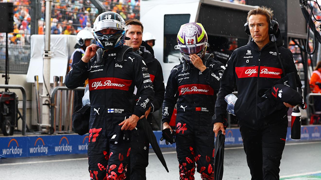 ZANDVOORT, NETHERLANDS - AUGUST 26: 16th placed qualifier Zhou Guanyu of China and Alfa Romeo F1 and 19th placed qualifier Valtteri Bottas of Finland and Alfa Romeo F1 walk in the Pitlane during qualifying ahead of the F1 Grand Prix of The Netherlands at Circuit Zandvoort on August 26, 2023 in Zandvoort, Netherlands. (Photo by Mark Thompson/Getty Images)