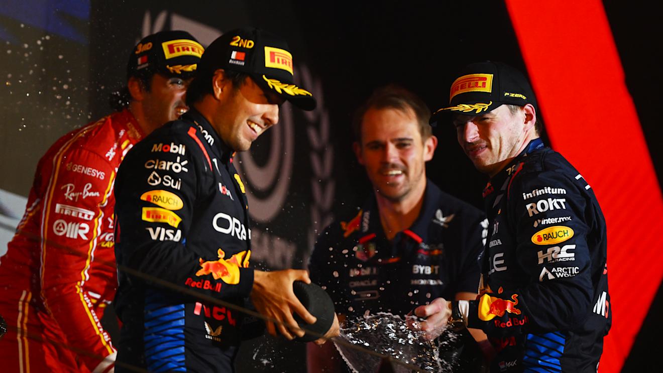BAHRAIN, BAHRAIN - MARCH 02: Race winner Max Verstappen of the Netherlands and Oracle Red Bull Racing, Second placed Sergio Perez of Mexico and Oracle Red Bull Racing, Third placed Carlos Sainz of Spain and Ferrari and Tom Hart, Performance Engineer at Oracle Red BullÂ Racing celebrate on the podium during the F1 Grand Prix of Bahrain at Bahrain International Circuit on March 02, 2024 in Bahrain, Bahrain. (Photo by Clive Mason/Getty Images)