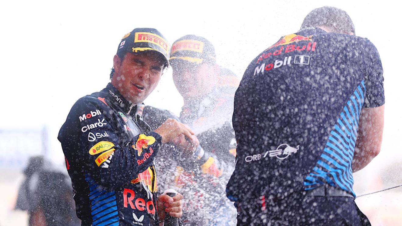 SUZUKA, JAPAN - APRIL 07: Second placed Sergio Perez of Mexico and Oracle Red Bull Racing celebrates with Craig Dear, Principal Aerodynamicist at Oracle RedÂ BullÂ Racing on the podium during the F1 Grand Prix of Japan at Suzuka International Racing Course on April 07, 2024 in Suzuka, Japan. (Photo by Bryn Lennon - Formula 1/Formula 1 via Getty Images)