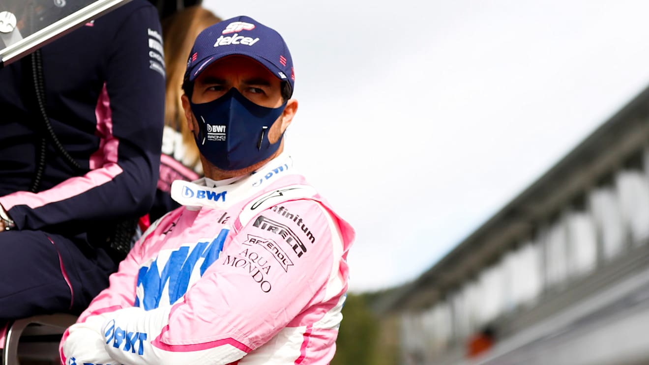 Sergio Perez, Racing Point, talks with team mates on the pit wall