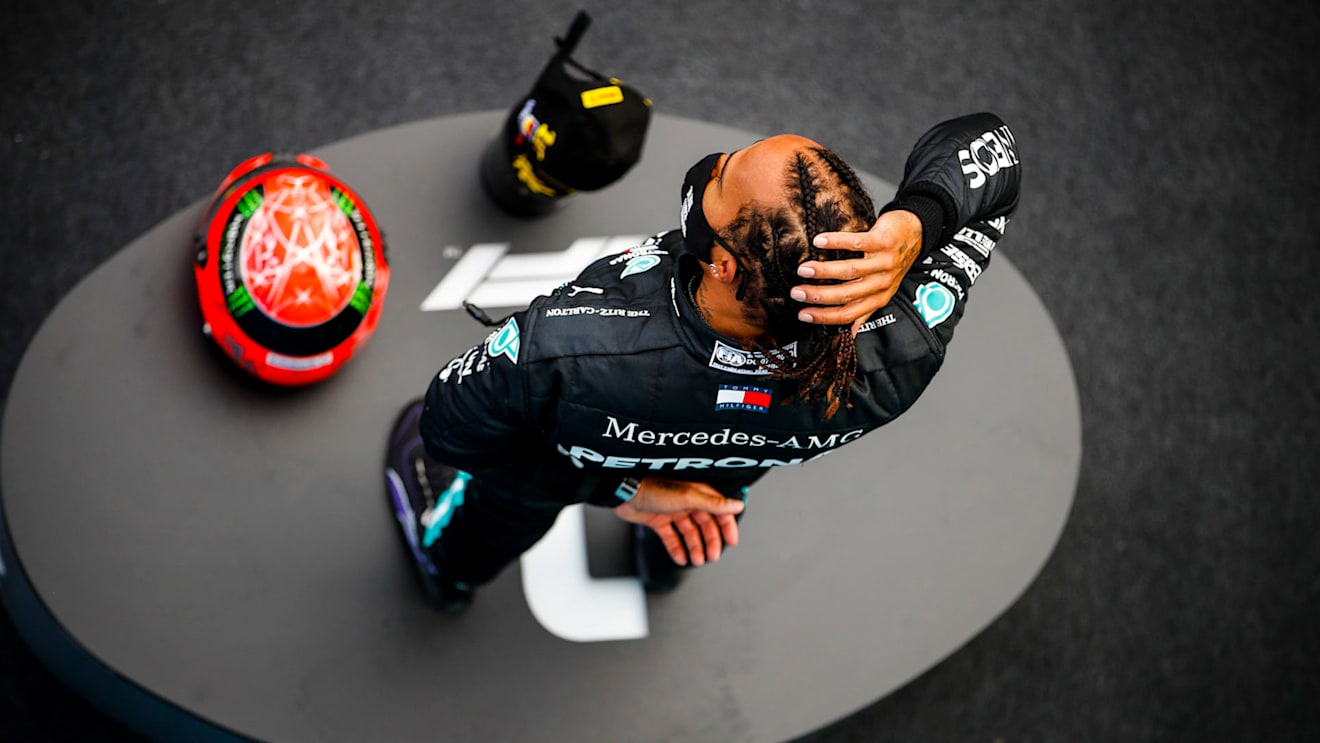 Lewis Hamilton, Mercedes-AMG Petronas F1, 1st position, on the podium with his trophy and the helmet of Michael Schumacher