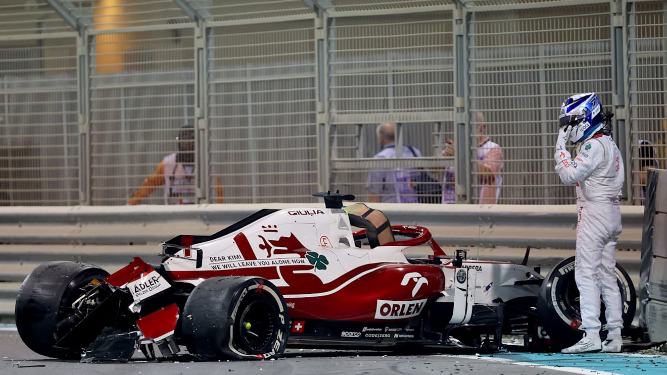 Alfa Romeo's Finnish driver Kimi Raikkonen stands by is car after he crashed at the Yas Marina Circuit during the second free practice session of the Abu Dhabi Formula One Grand Prix on December 10, 2021. (Photo by Giuseppe CACACE / AFP) (Photo by GIUSEPPE CACACE/AFP via Getty Images)