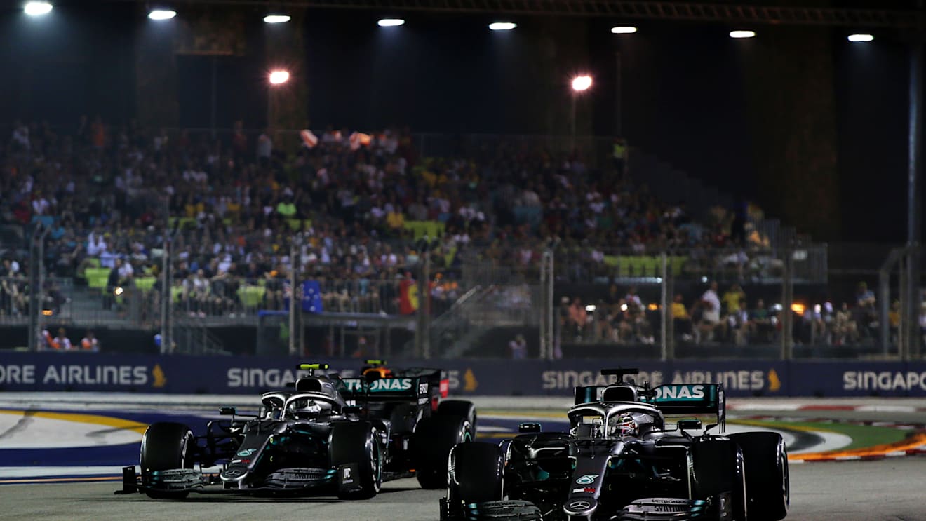 SINGAPORE, SINGAPORE - SEPTEMBER 22: Lewis Hamilton of Great Britain driving the (44) Mercedes AMG Petronas F1 Team Mercedes W10 and Valtteri Bottas driving the (77) Mercedes AMG Petronas F1 Team Mercedes W10 on track during the F1 Grand Prix of Singapore at Marina Bay Street Circuit on September 22, 2019 in Singapore. (Photo by Charles Coates/Getty Images)