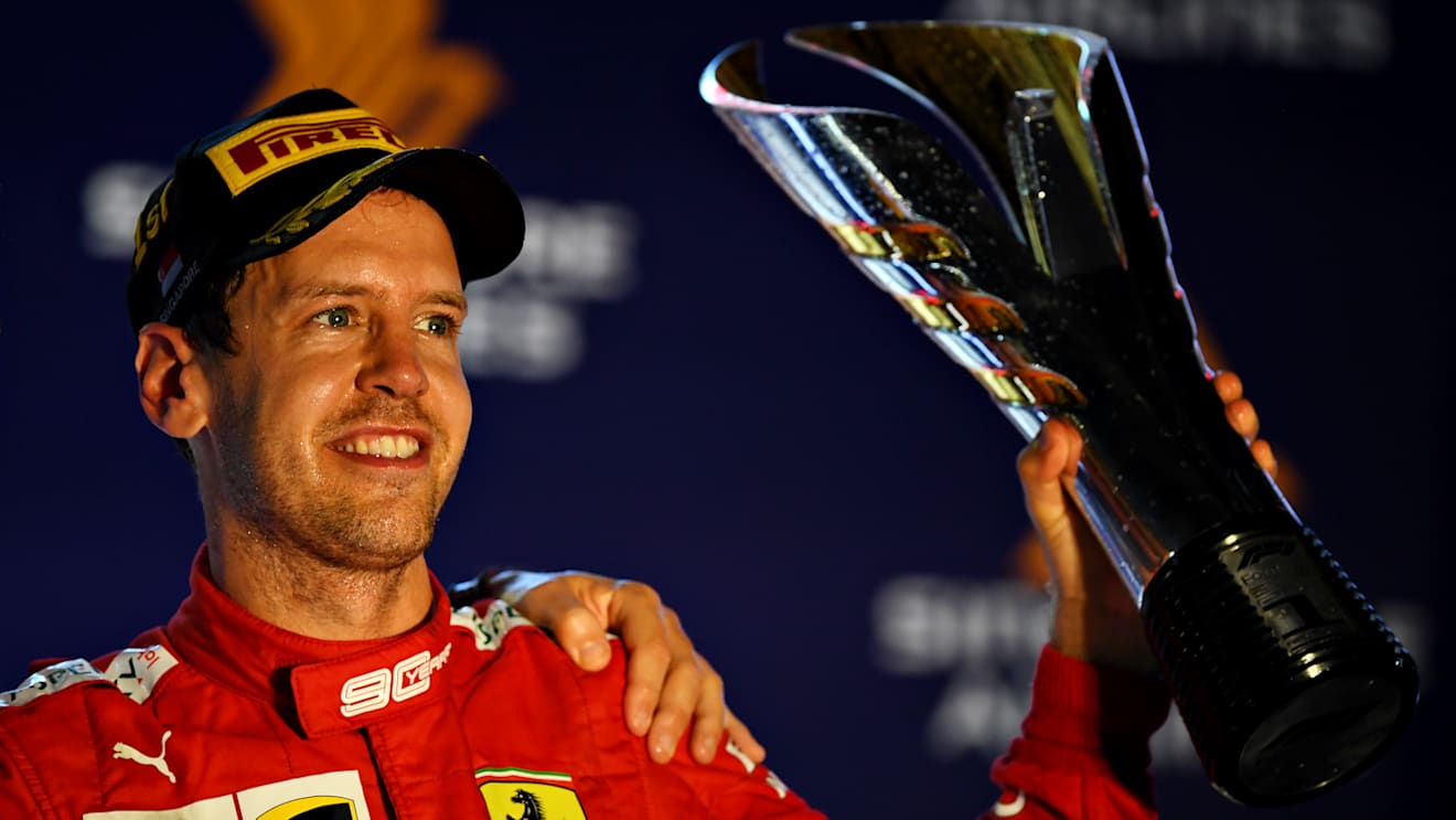 SINGAPORE, SINGAPORE - SEPTEMBER 22: Race winner Sebastian Vettel of Germany and Ferrari celebrates on the podium during the F1 Grand Prix of Singapore at Marina Bay Street Circuit on September 22, 2019 in Singapore. (Photo by Clive Mason/Getty Images)