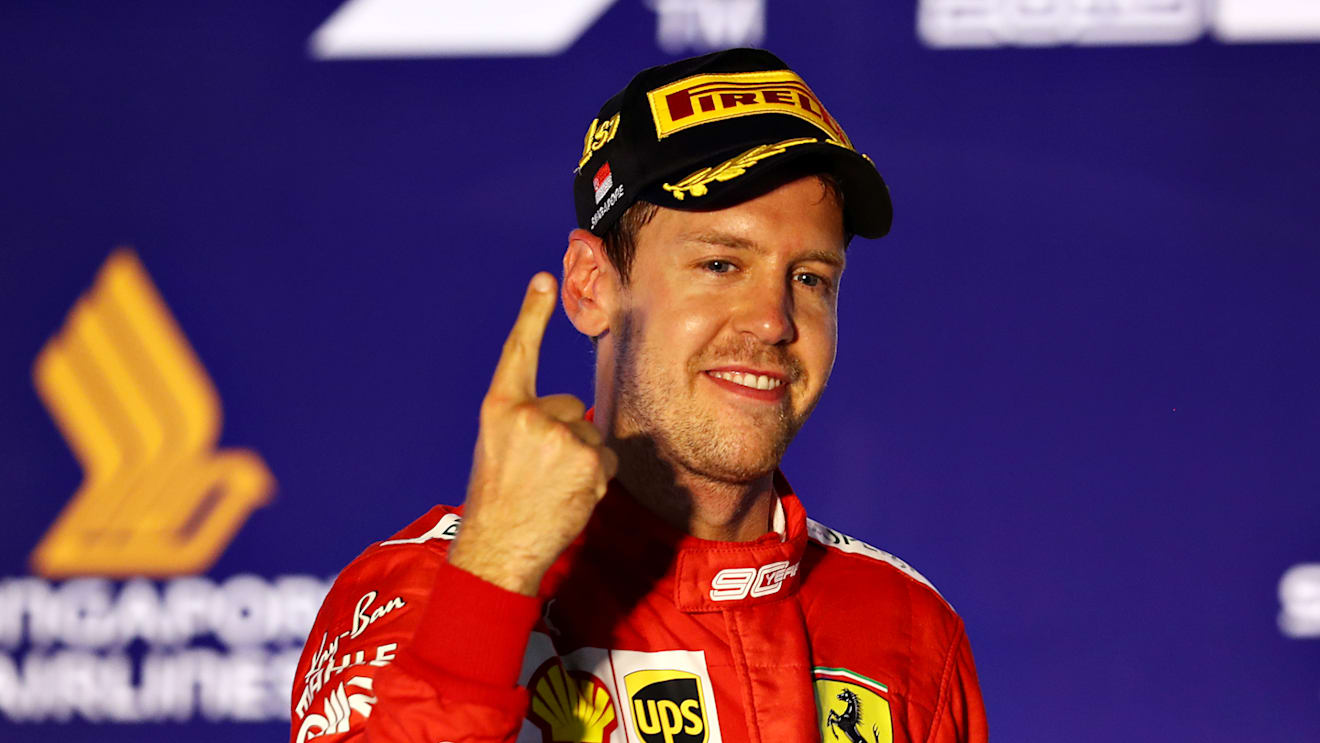 SINGAPORE, SINGAPORE - SEPTEMBER 22: Race winner Sebastian Vettel of Germany and Ferrari celebrates on the podium during the F1 Grand Prix of Singapore at Marina Bay Street Circuit on September 22, 2019 in Singapore. (Photo by Mark Thompson/Getty Images)
