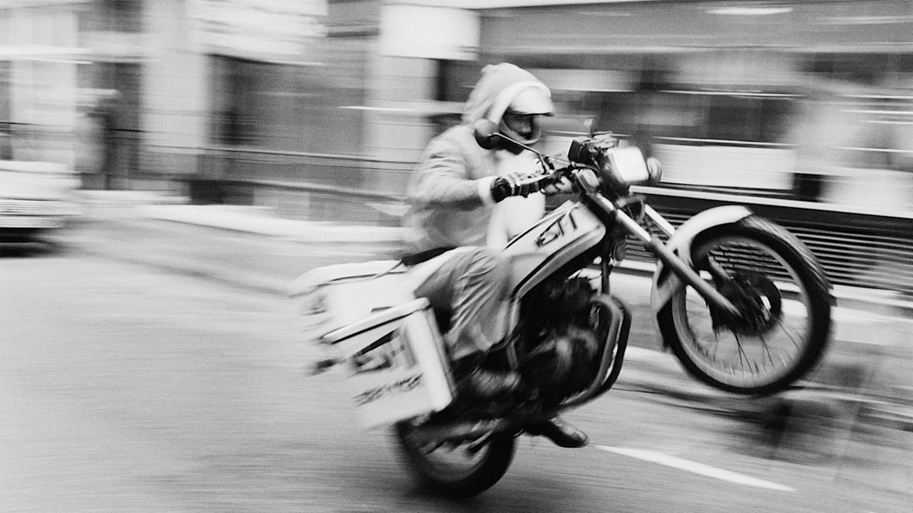 Damon Hill pulls a wheelie for the camera during his motorcycle messenger days