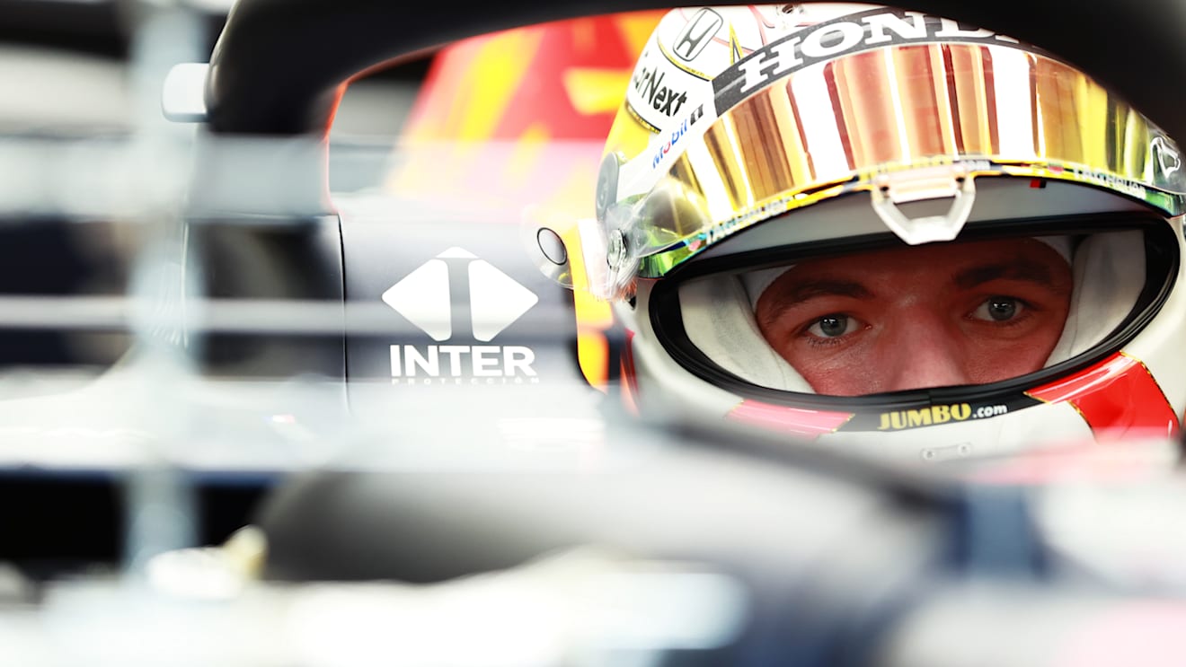Max Verstappen deep in concentration as he prepares to leave the pits in his Red Bull RB16B