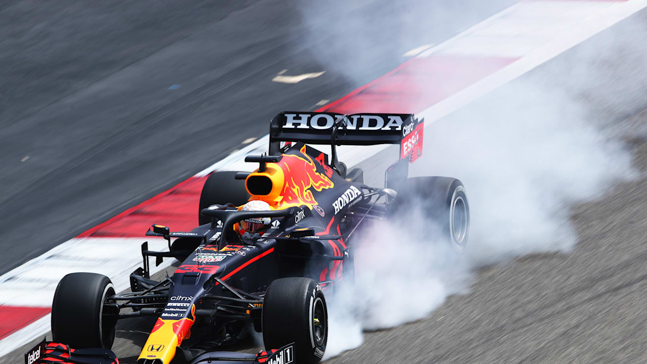 A spectacular puff of smoke emitted by Verstappen's RB16B as he locks up
