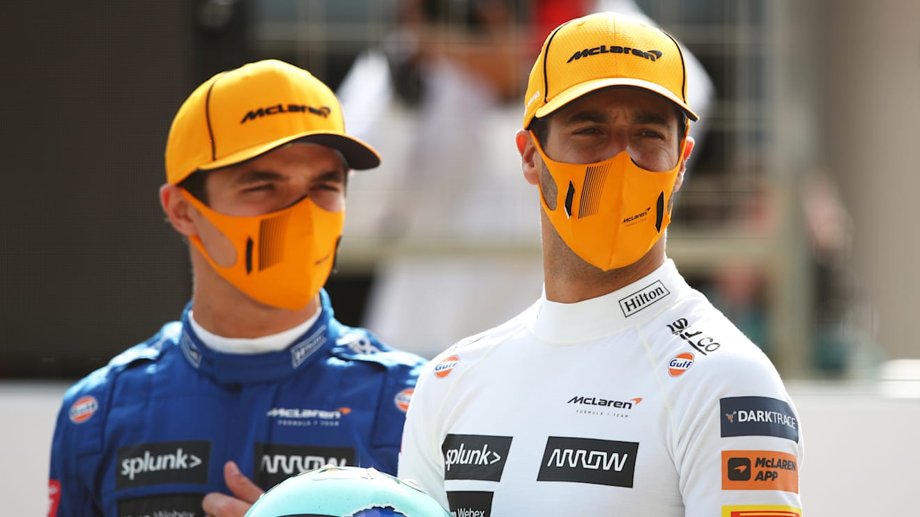 Something catches the eyes of the McLaren drivers as they pose for a grid photo in the morning. Daniel Ricciardo (R) took the wheel first