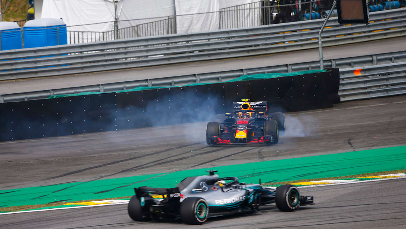 Lewis Hamilton, Mercedes AMG F1 W09, passes a spinning Max Verstappen, Red Bull Racing RB14 Tag Heuer, after the latter suffers a collision with Esteban Ocon, Force India VJM11 Mercedes during the Brazilian GP on November 11, 2018 in Autodromo Jose Carlos Pace, Brazil. (Photo by Andy Hone / LAT Images)