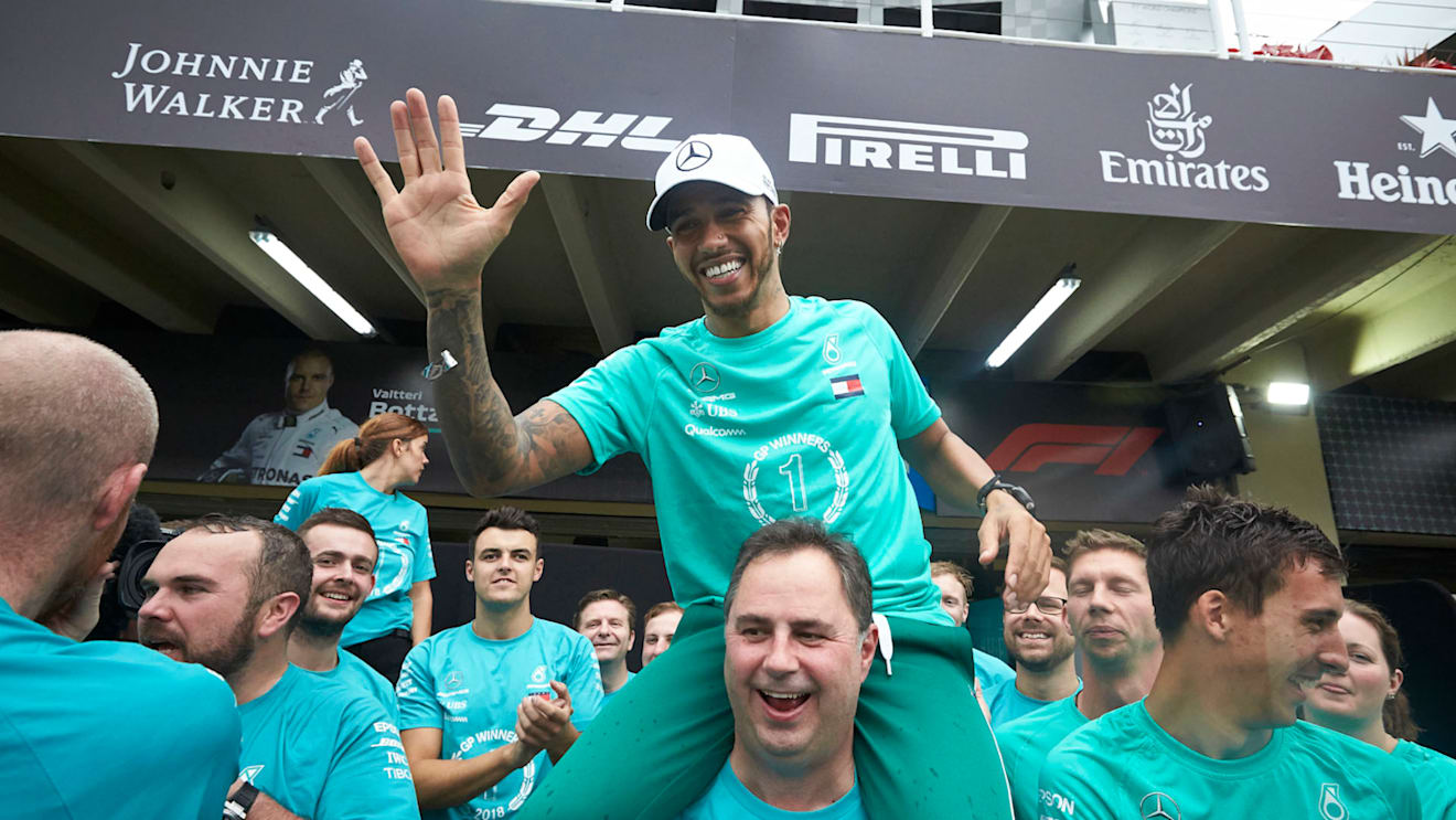Lewis Hamilton, Mercedes AMG F1, on the shoulders of Ron Meadows, Sporting Director, Mercedes AMG, celebrates with the Mercedes team during the Brazilian GP at Autódromo José Carlos Pace on November 11, 2018. (Photo by Steve Etherington / LAT Images)