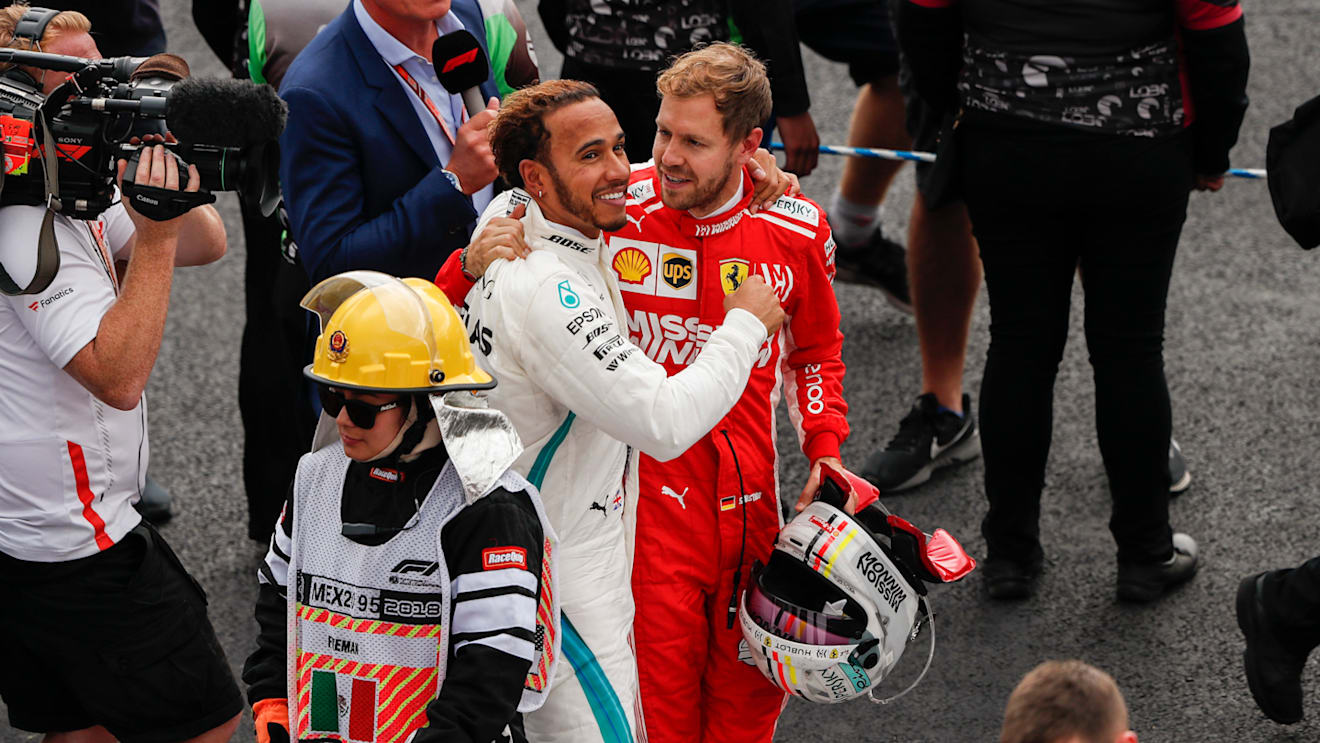 AUTODROMO HERMANOS RODRIGUEZ, MEXICO - OCTOBER 28: Title rival Sebastian Vettel, Ferrari, offers his congratulations to drivers championship winner Lewis Hamilton, Mercedes AMG F1 during the Mexican GP at Autodromo Hermanos Rodriguez on October 28, 2018 in Autodromo Hermanos Rodriguez, Mexico. (Photo by Joe Portlock / LAT Images)