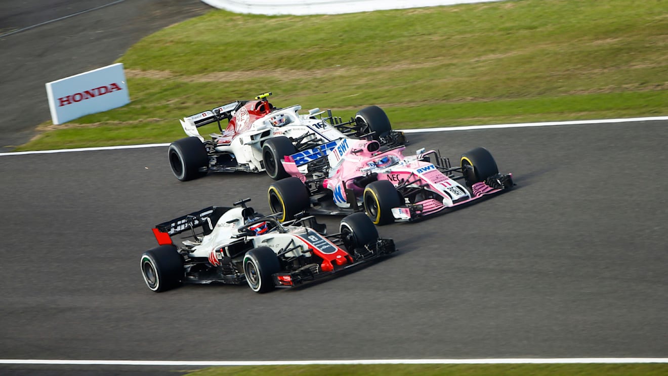 SUZUKA, JAPAN - OCTOBER 07: Romain Grosjean, Haas F1 Team VF-18, battles with Sergio Perez, Racing Point Force India VJM11 and Charles Leclerc, Sauber C37 Ferrari during the Japanese GP at Suzuka on October 07, 2018 in Suzuka, Japan. (Photo by Andy Hone / LAT Images)