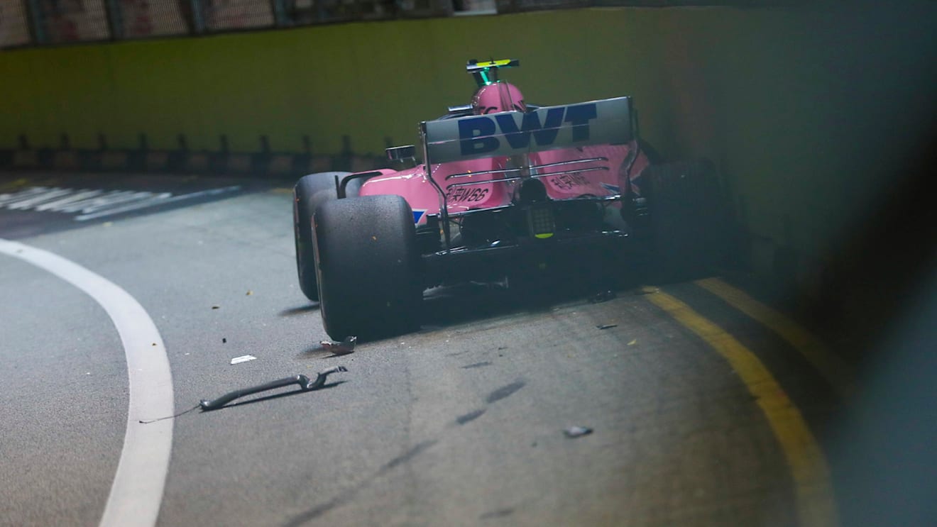 SINGAPORE STREET CIRCUIT, SINGAPORE - SEPTEMBER 16: Esteban Ocon, Racing Point Force India VJM11, crashes out after contact with his team mate at the start during the Singapore GP at Singapore Street Circuit on September 16, 2018 in Singapore Street Circuit, Singapore. (Photo by Zak Mauger / LAT Images)