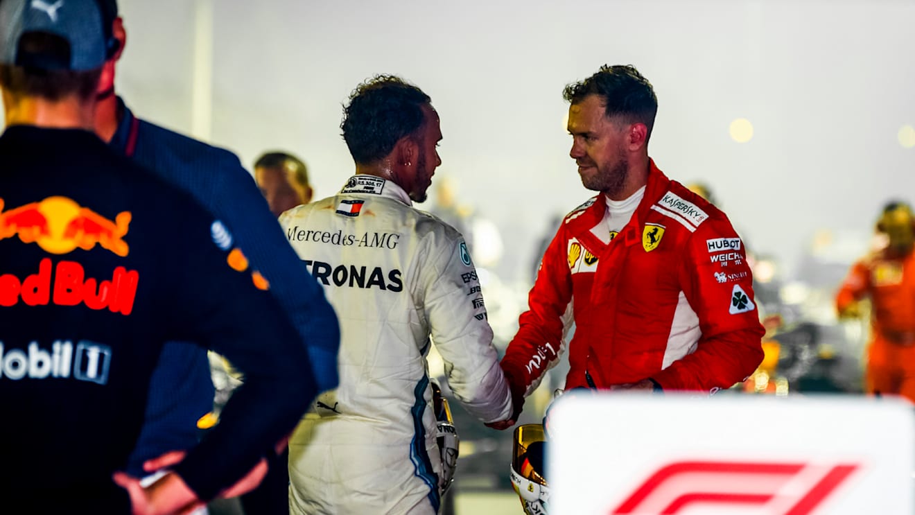 SINGAPORE STREET CIRCUIT, SINGAPORE - SEPTEMBER 16: Sebastian Vettel, Ferrari, 3rd position, congratulates Lewis Hamilton, Mercedes AMG F1, 1st position, in Parc Ferme during the Singapore GP at Singapore Street Circuit on September 16, 2018 in Singapore Street Circuit, Singapore. (Photo by Andy Hone / LAT Images)