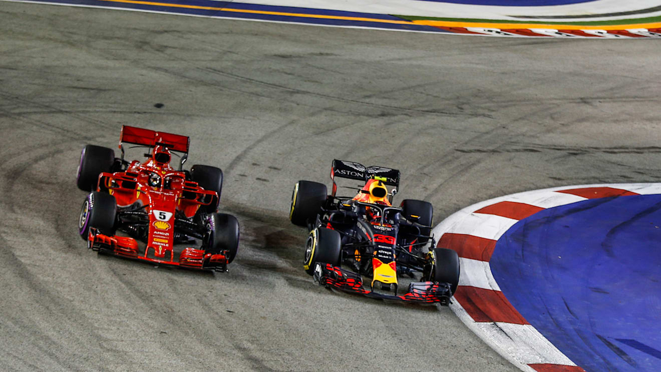 SINGAPORE STREET CIRCUIT, SINGAPORE - SEPTEMBER 16: Sebastian Vettel, Ferrari SF71H and Max Verstappen, Red Bull Racing RB14 battle during the Singapore GP at Singapore Street Circuit on September 16, 2018 in Singapore Street Circuit, Singapore. (Photo by Manuel Goria / Sutton Images)