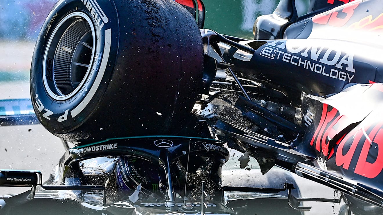 MONZA, ITALY - SEPTEMBER 12: Max Verstappen of the Netherlands driving the (33) Red Bull Racing RB16B Honda and Lewis Hamilton of Great Britain driving the (44) Mercedes AMG Petronas F1 Team Mercedes W12 crash during the F1 Grand Prix of Italy at Autodromo di Monza on September 12, 2021 in Monza, Italy.