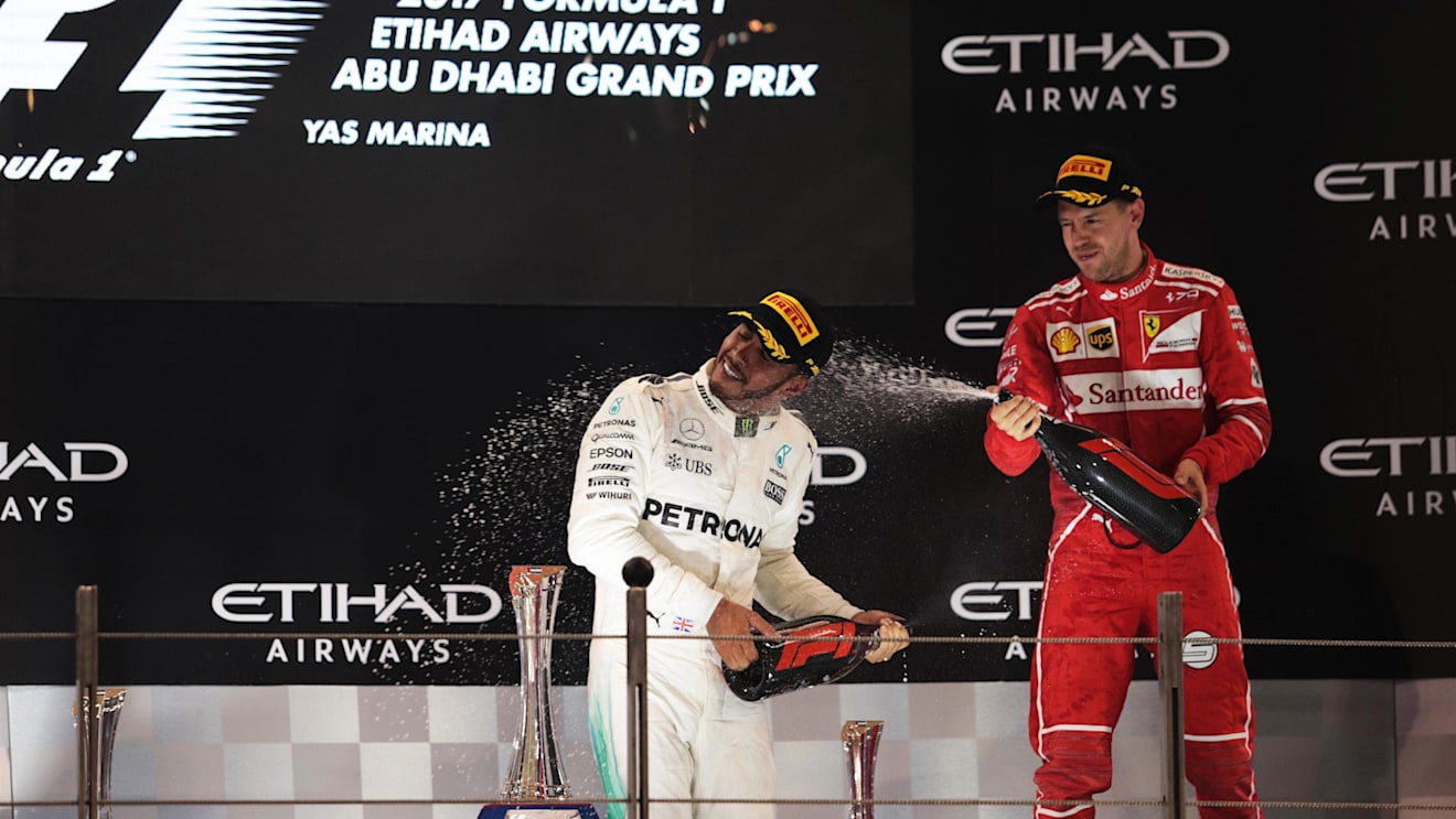 Lewis Hamilton (GBR) Mercedes AMG F1 and Sebastian Vettel (GER) Ferrari celebrate on the podium at Formula One World Championship, Rd20, Abu Dhabi Grand Prix, Race, Yas Marina Circuit, Abu Dhabi, UAE, Sunday 26 November 2017. © Manuel Goria/Sutton Images