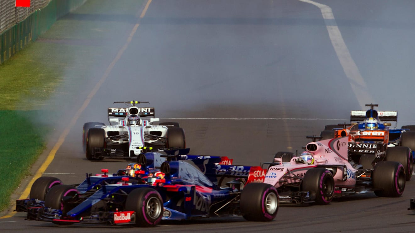 Daniil Kvyat (RUS) Scuderia Toro Rosso STR12, Carlos Sainz jr (ESP) Scuderia Toro Rosso STR12 and Sergio Perez (MEX) Force India VJM10 battle for position F1 World Championship, Australian Grand Prix. ©Sutton Motorsport Images