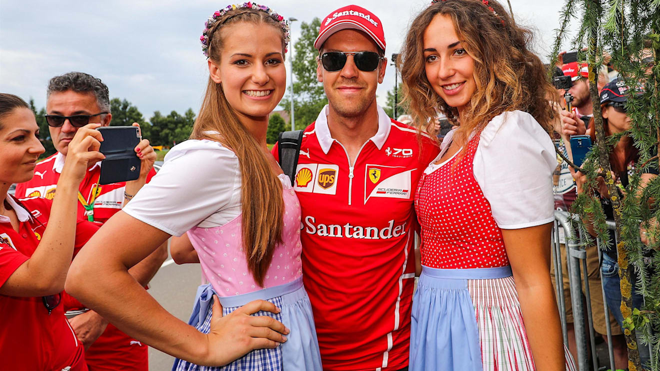 Sebastian Vettel (GER) Ferrari and girls at Formula One World Championship, Rd9, Austrian Grand Prix, Qualifying, Spielberg, Austria, Saturday 8 July 2017. © Sutton Images