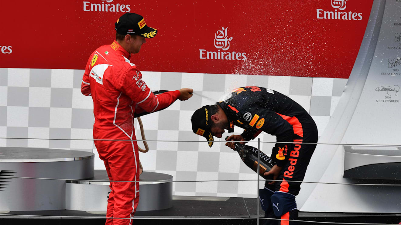 Sebastian Vettel (GER) Ferrari and Daniel Ricciardo (AUS) Red Bull Racing celebrate on the podium at Formula One World Championship, Rd9, Austrian Grand Prix, Race, Spielberg, Austria, Sunday 9 July 2017. © Sutton Images