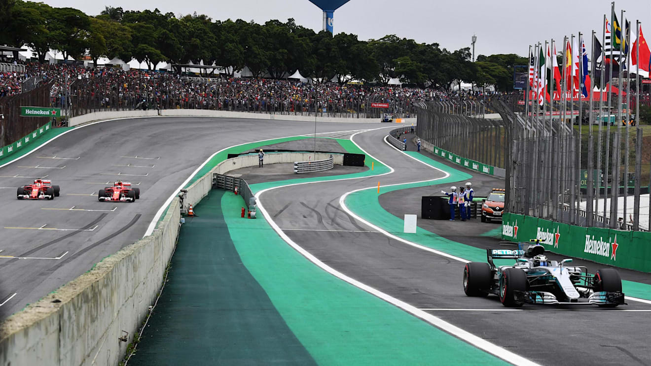 Pole sitter Valtteri Bottas (FIN) Mercedes-Benz F1 W08 Hybrid arrives in parc ferme whilst Sebastian Vettel (GER) Ferrari SF70-H and Kimi Raikkonen (FIN) Ferrari SF70-H park on track at Formula One World Championship, Rd19, Brazilian Grand Prix, Qualifying, Interlagos, Sao Paulo, Brazil, Saturday 11 November 2017. © Mark Sutton/Sutton Images